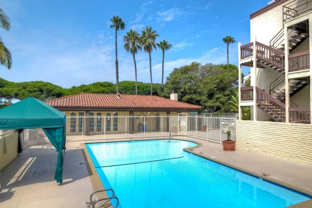 a view of a patio with glass top table and chairs