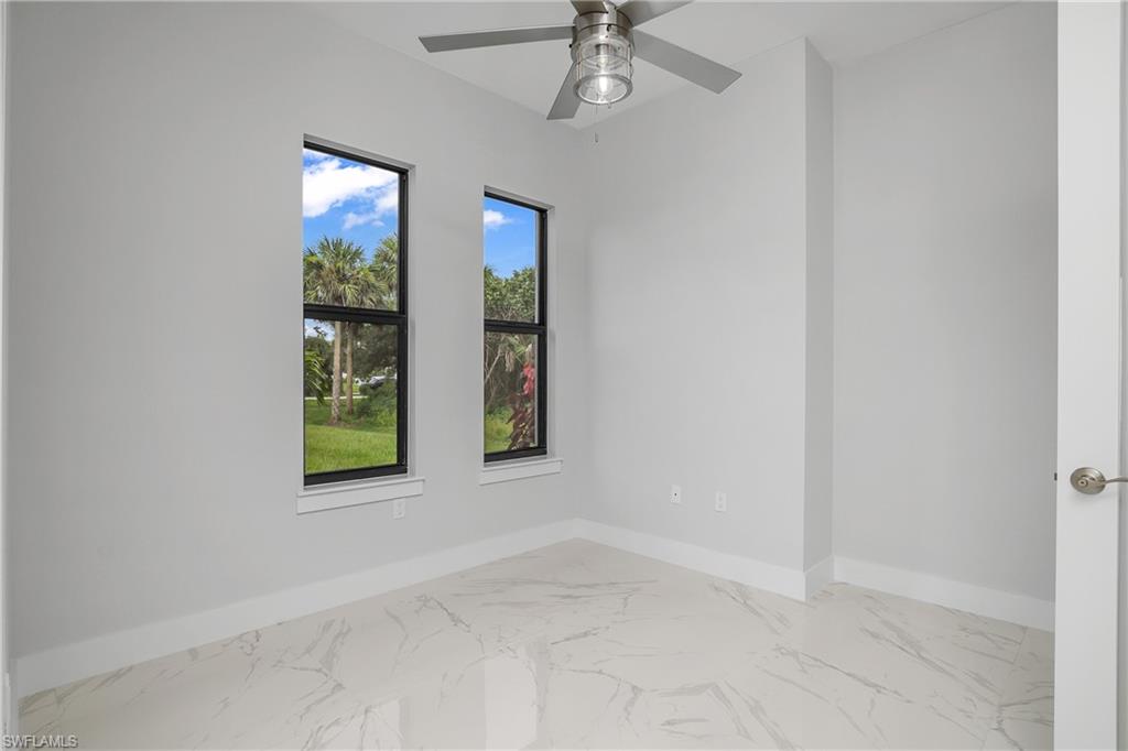 791 14th Street Northeast Naples, FL 34120 - Photo 15 of 46 Empty room featuring marble finish flooring and a ceiling fan