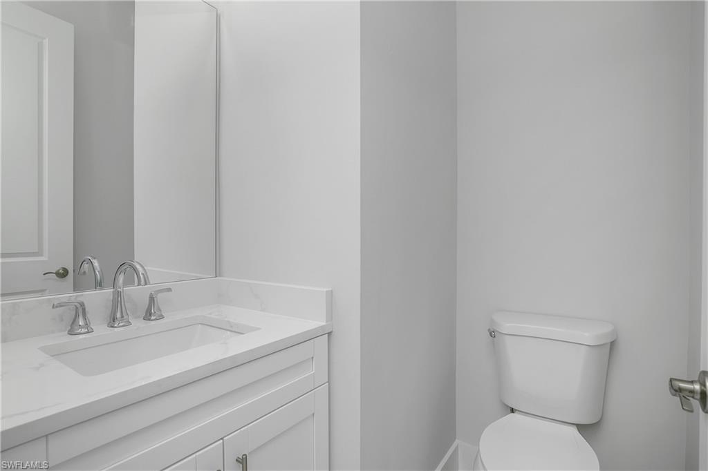 791 14th Street Northeast Naples, FL 34120 - Photo 24 of 46 Bathroom featuring toilet and vanity