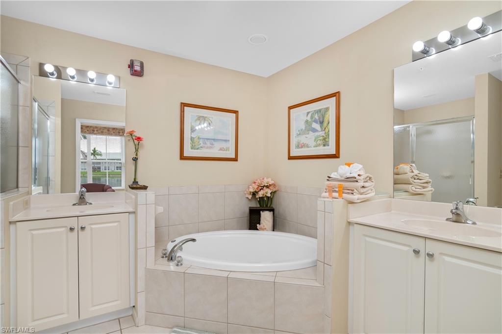 791 14th Street Northeast Naples, FL 34120 - Photo 29 of 46 Bathroom with a shower stall, two vanities, and a bath
