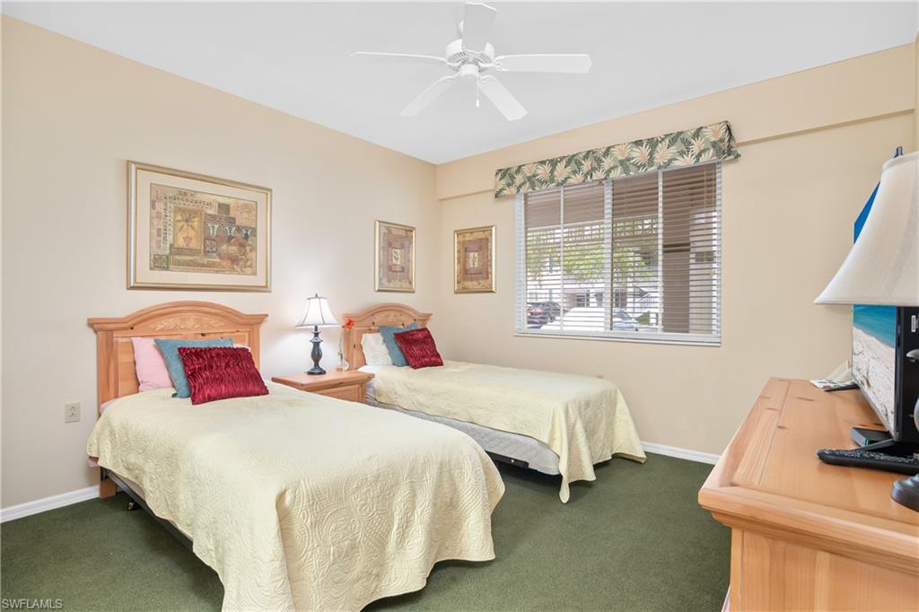 791 14th Street Northeast Naples, FL 34120 - Photo 31 of 46 Bedroom with dark colored carpet and ceiling fan