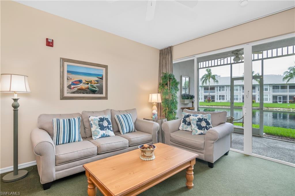 791 14th Street Northeast Naples, FL 34120 - Photo 34 of 46 Carpeted living area with ceiling fan and a water view