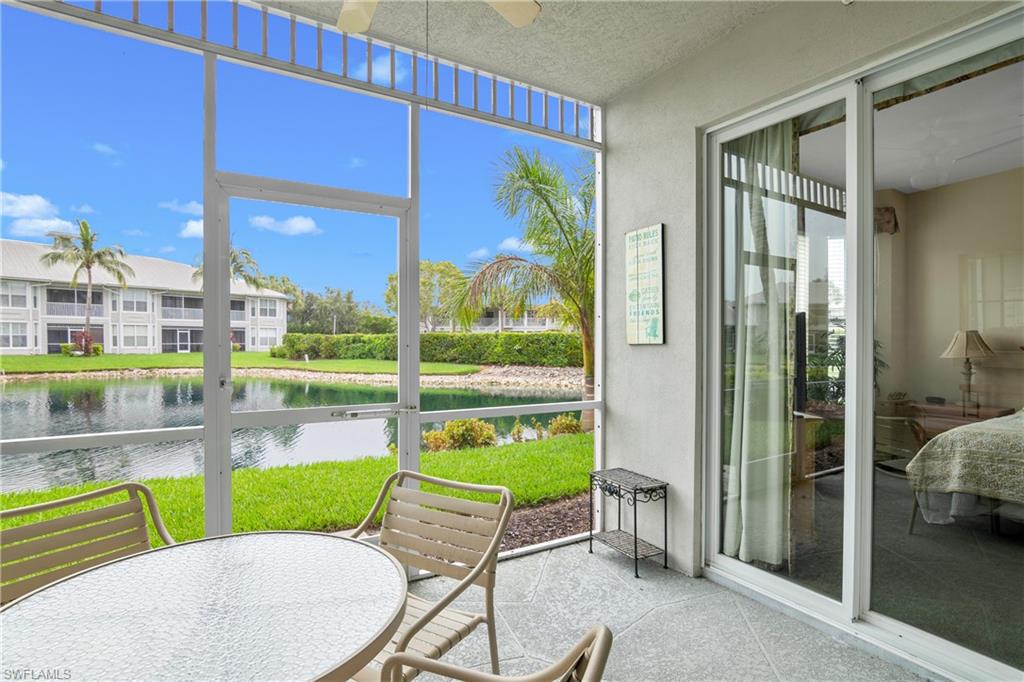 791 14th Street Northeast Naples, FL 34120 - Photo 40 of 46 Sunroom with a ceiling fan, outdoor dining space, a water view, and a patio area