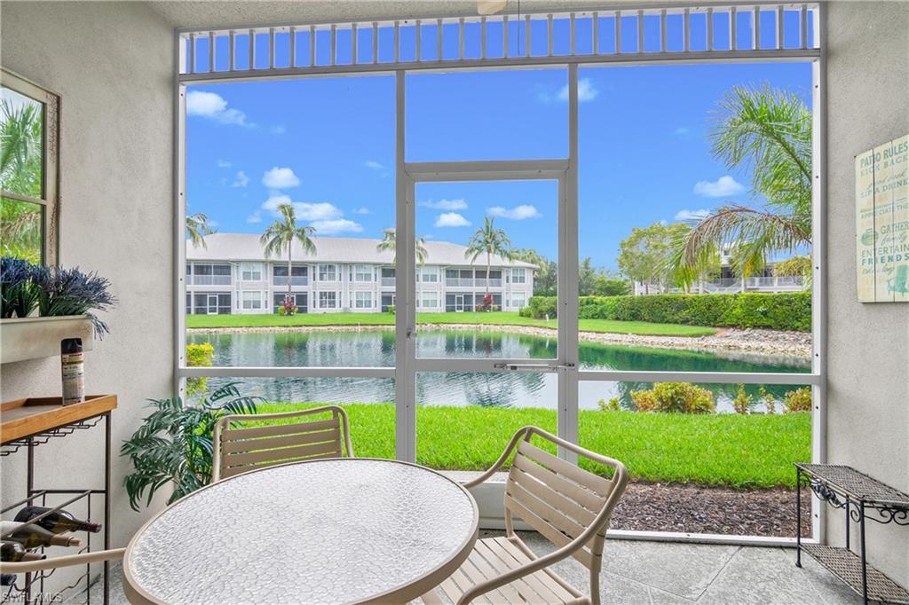 791 14th Street Northeast Naples, FL 34120 - Photo 41 of 46 Sunroom / solarium with a water view and outdoor dining area