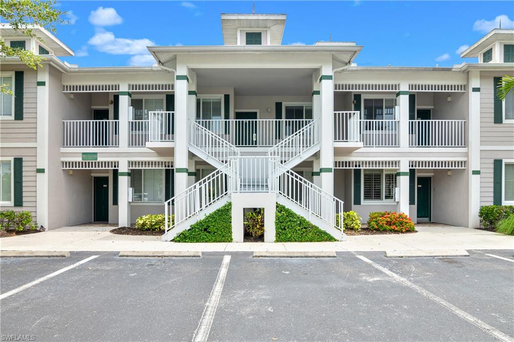 791 14th Street Northeast Naples, FL 34120 - Photo 45 of 46 View of apartment building / complex featuring stairs and uncovered parking