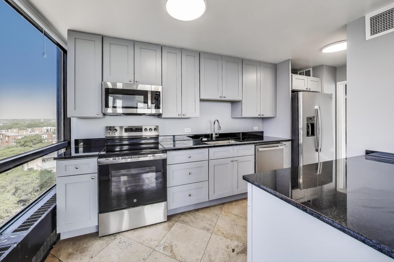 5415 North Sheridan Road, Unit 1401 Chicago, IL 60640 - Photo 14 of 46 a kitchen with stainless steel appliances granite countertop a stove a sink and a refrigerator