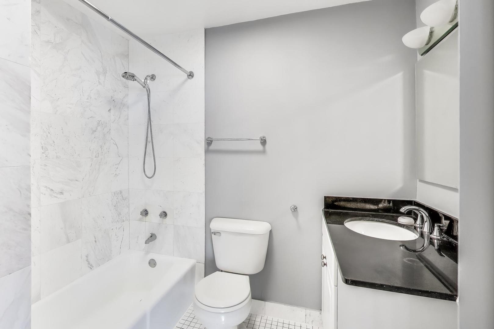 5415 North Sheridan Road, Unit 1401 Chicago, IL 60640 - Photo 28 of 46 a bathroom with a sink toilet and shower