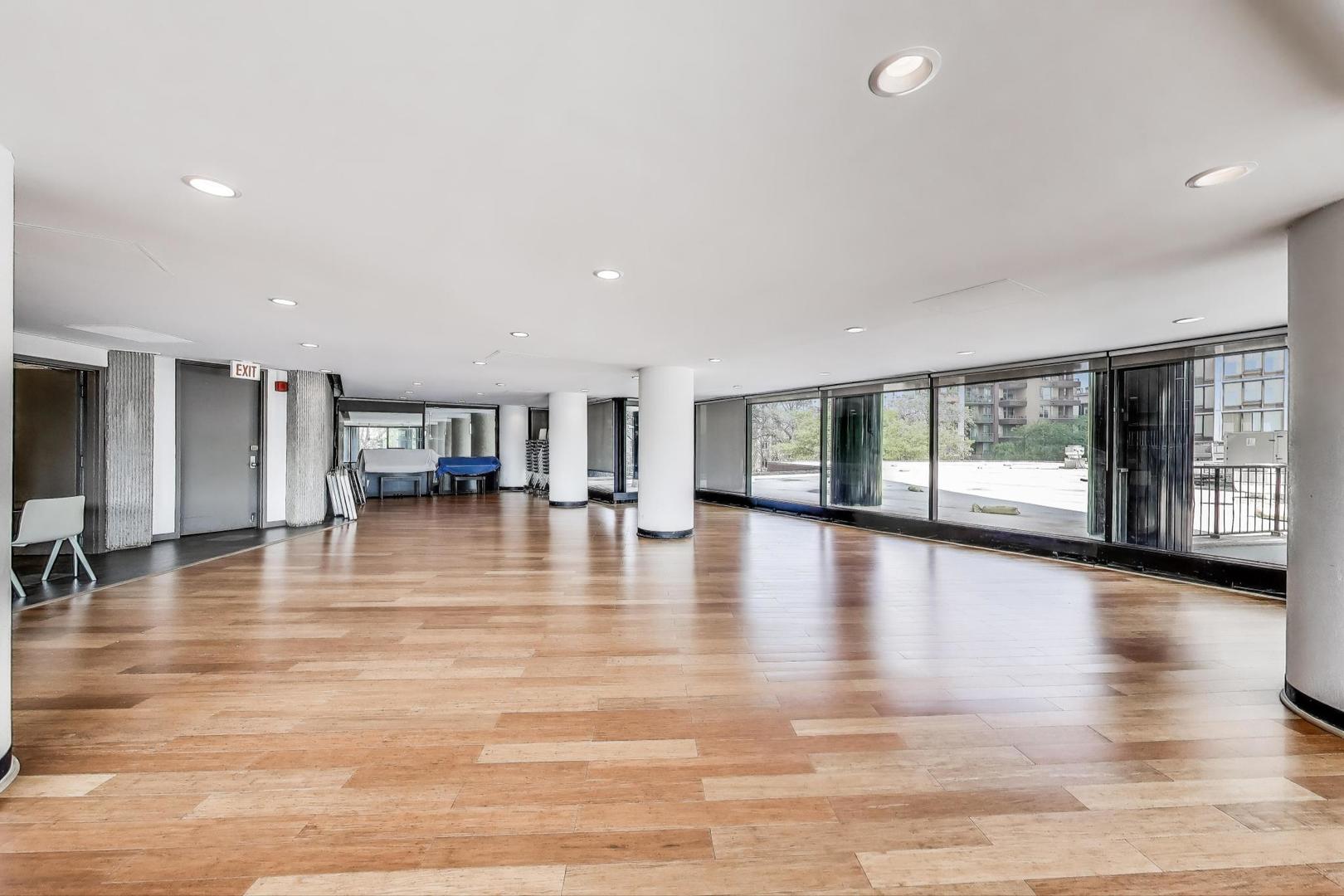 5415 North Sheridan Road, Unit 1401 Chicago, IL 60640 - Photo 33 of 46 a view of empty room with floor to ceiling window and wooden floor