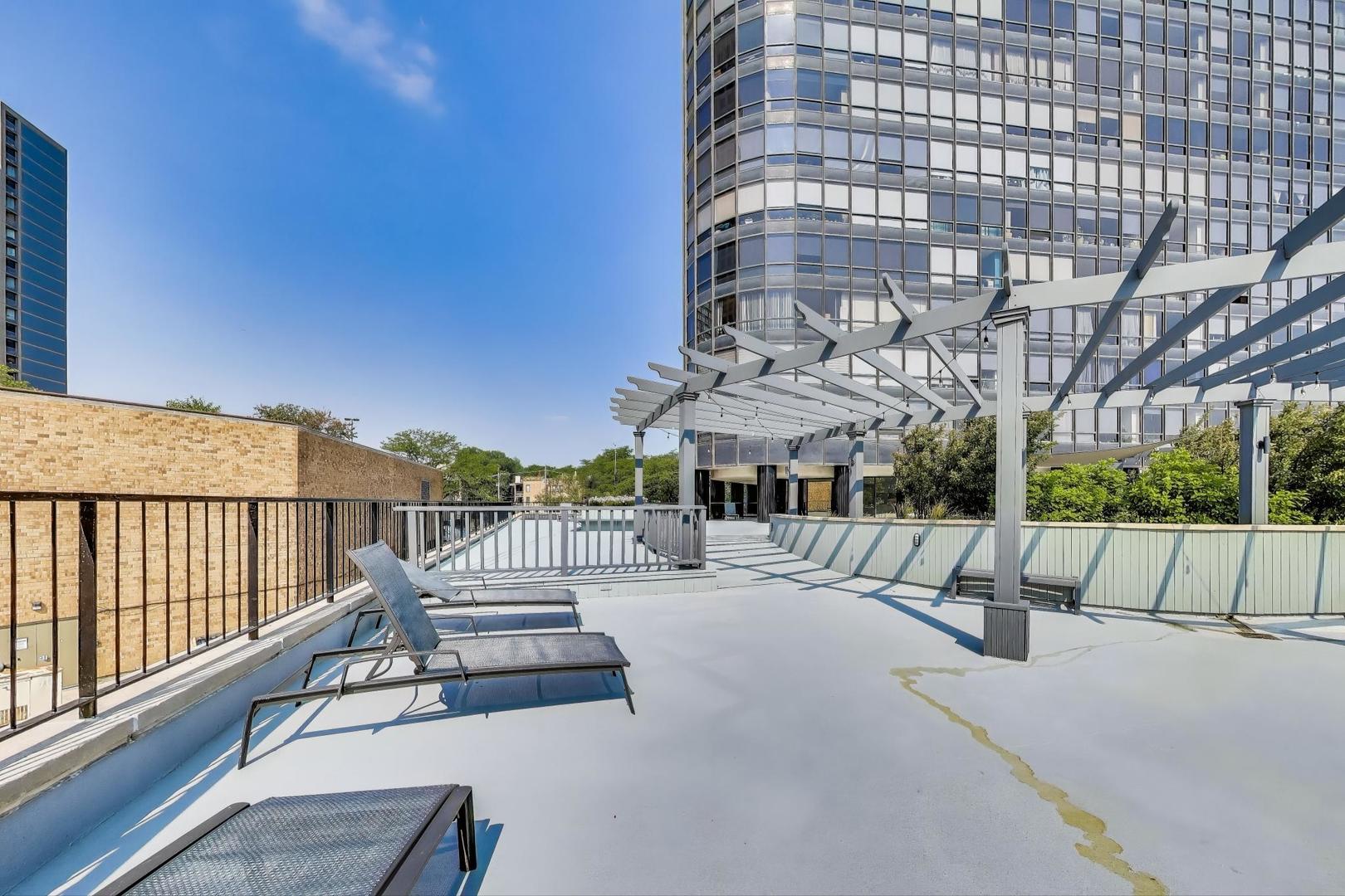 5415 North Sheridan Road, Unit 1401 Chicago, IL 60640 - Photo 44 of 46 a view of a balcony with two chairs and a table