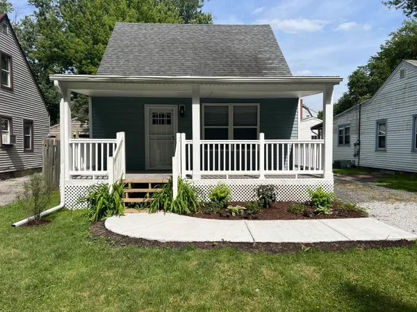a view of a house with a yard and a garden