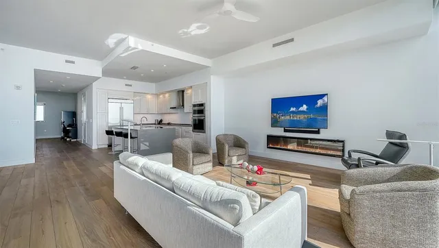 a view of a swimming pool with a lawn chairs and palm trees