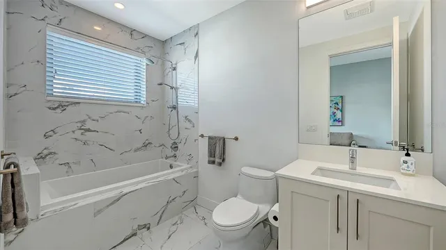 a view of a patio with a table and chairs under an umbrella
