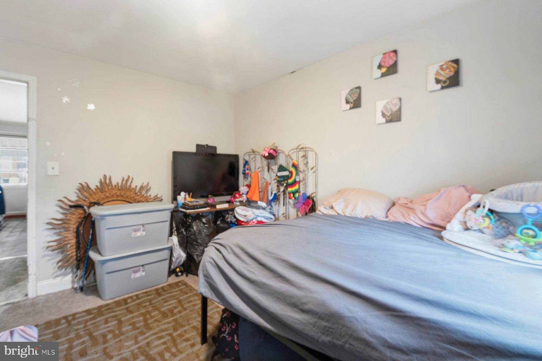 4931 Brookwood Road Baltimore, MD 21225 - Photo 8 of 25 a bedroom with a bed and furniture