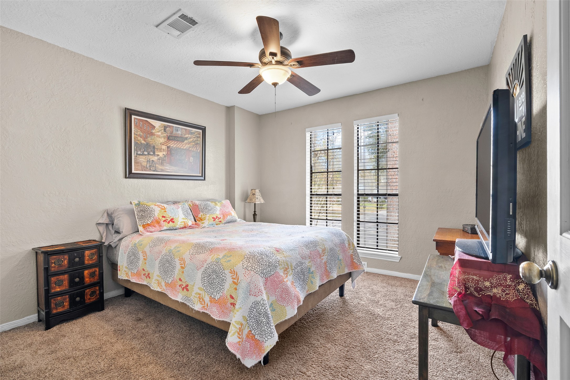 41 Windsor Drive Conroe, TX 77304 - Photo 28 of 39 Bedroom 4 with carpet flooring, ceiling fan with light fixture, and windows allowing for natural light. Neutral tones offer flexibility for a variety of uses.