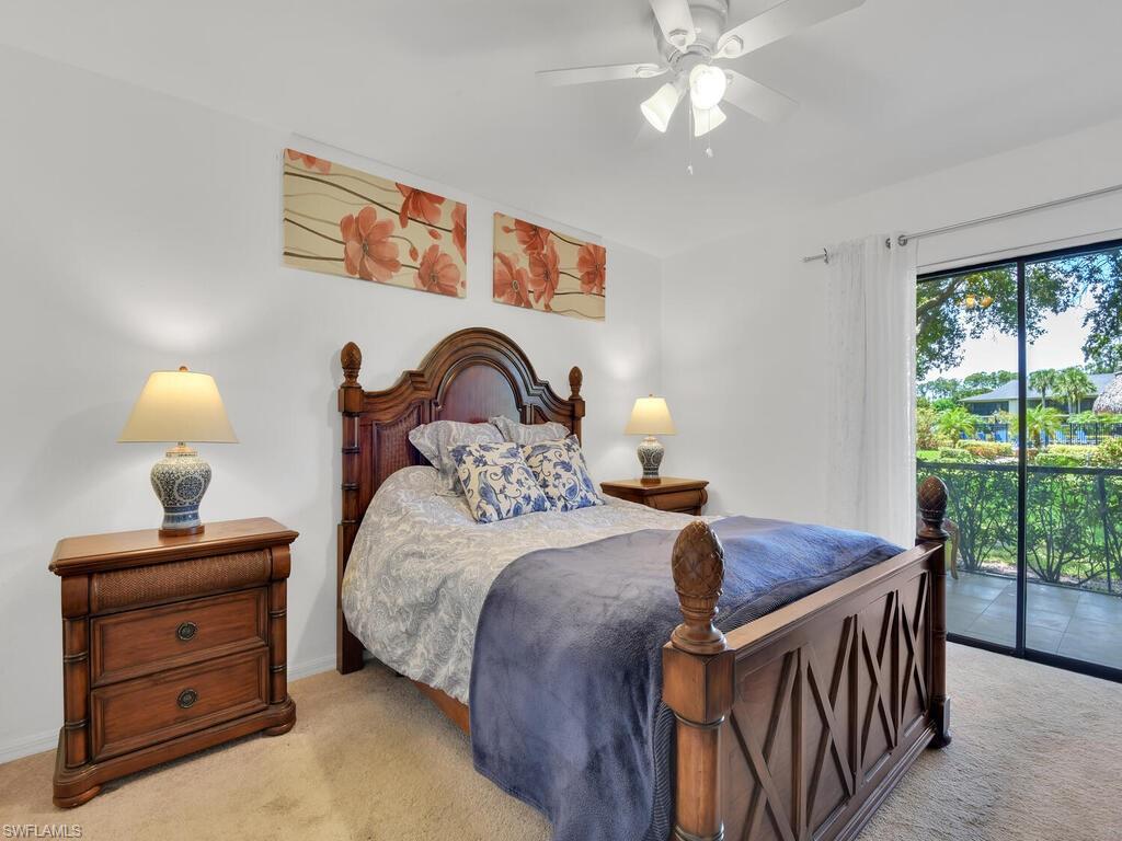 1208 Commonwealth Circle, Unit J102 Naples, FL 34116 - Photo 9 of 21 a bedroom with a bed and a dresser