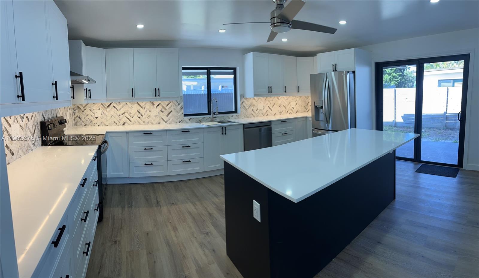 4640 Southwest 94th Court Miami, FL 33165 - Photo 18 of 37 a kitchen with a wooden floor window and cabinets
