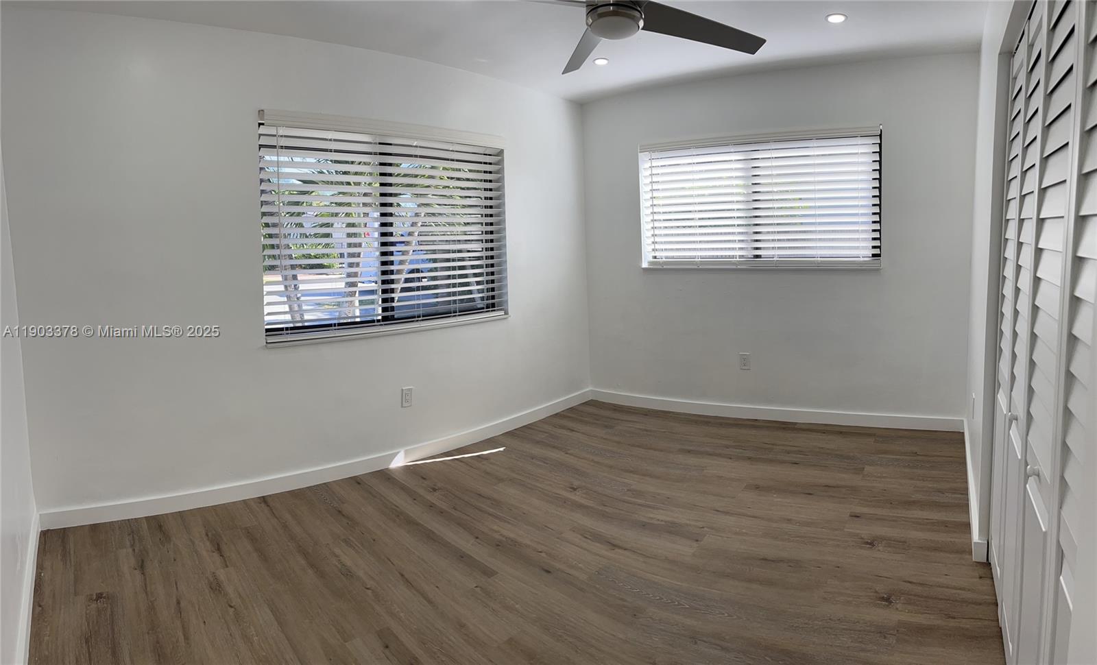 4640 Southwest 94th Court Miami, FL 33165 - Photo 20 of 37 an empty room with wooden floor and windows