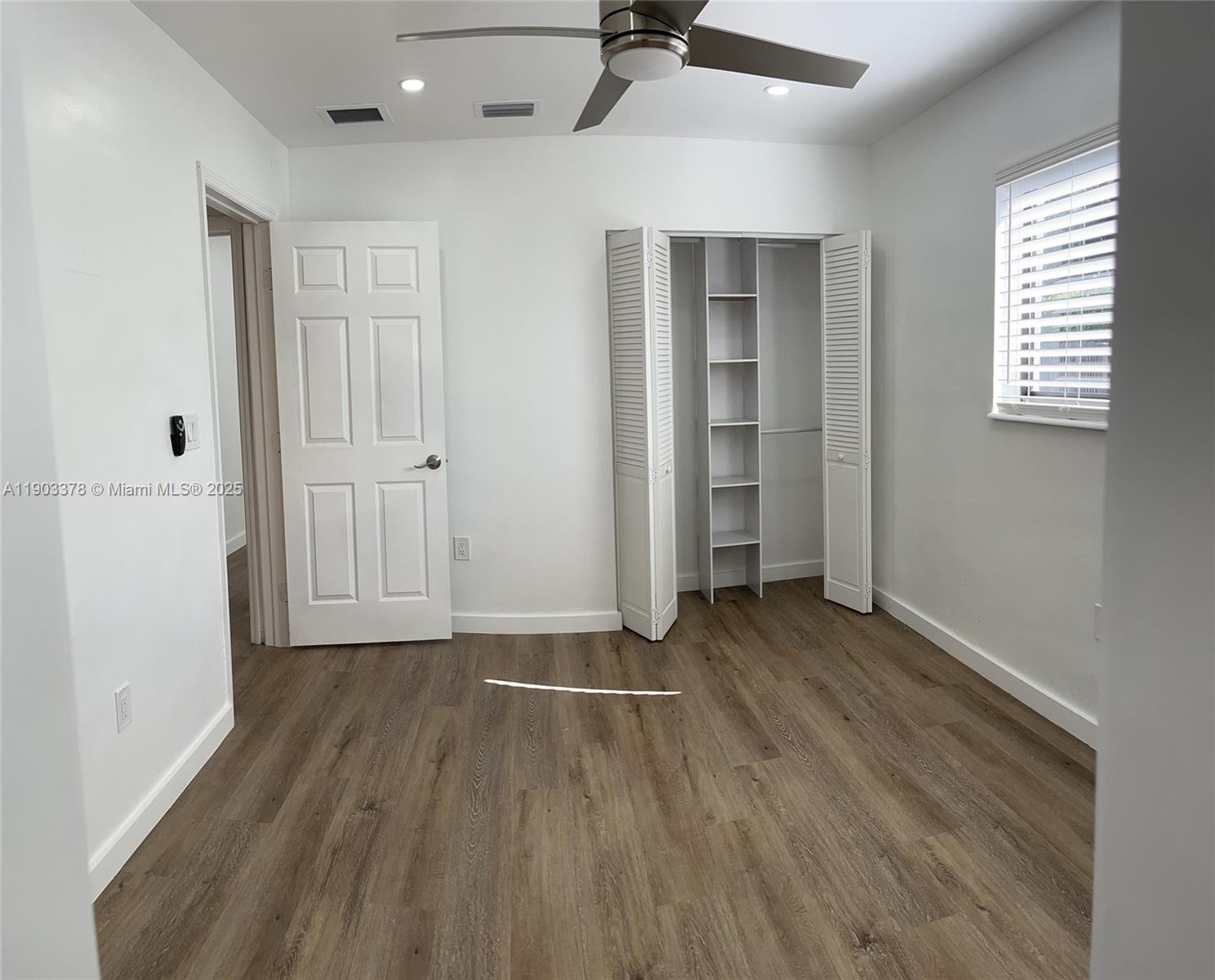 4640 Southwest 94th Court Miami, FL 33165 - Photo 21 of 37 an empty room with wooden floor and windows