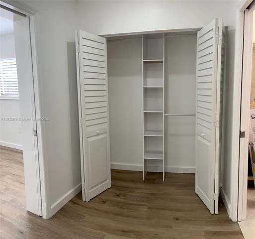 a view of walk in closet with empty racks