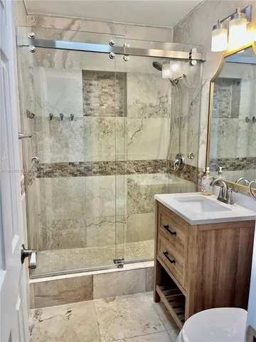 a bathroom with a sink mirror toilet and bathtub