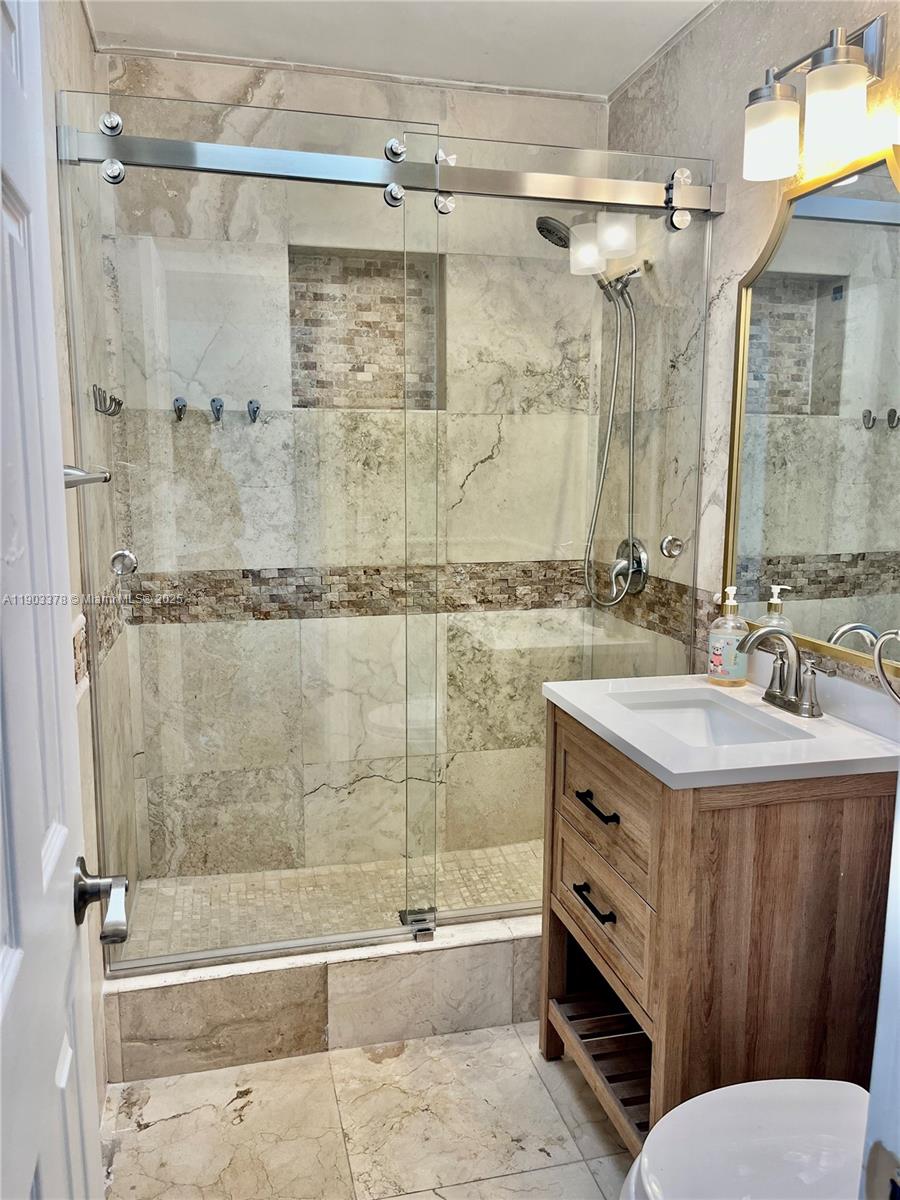 4640 Southwest 94th Court Miami, FL 33165 - Photo 24 of 37 a bathroom with a sink mirror toilet and bathtub