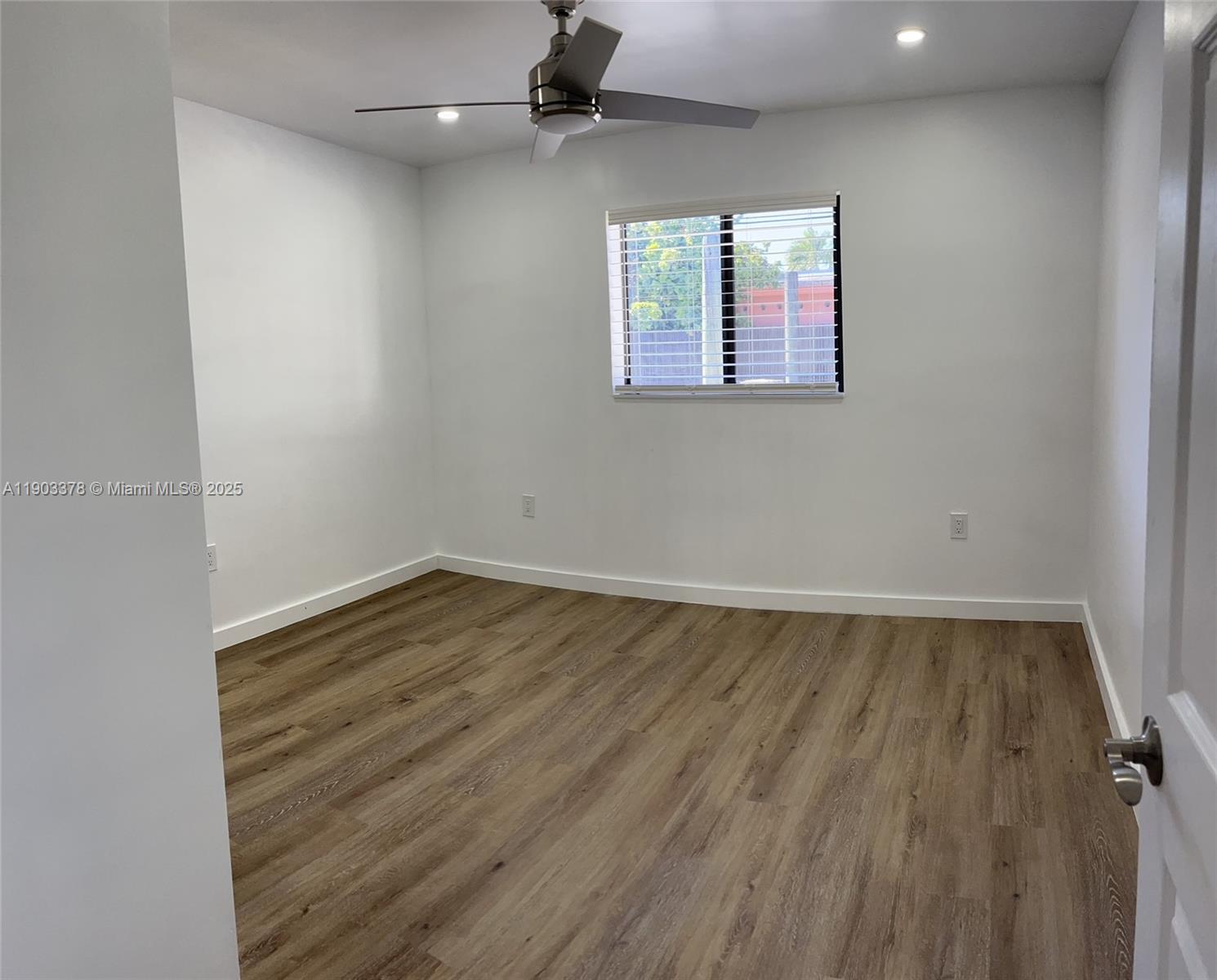 4640 Southwest 94th Court Miami, FL 33165 - Photo 25 of 37 an empty room with wooden floor and windows