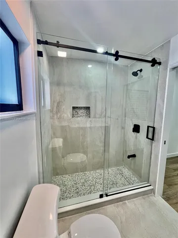 a bathroom with a shower and a bathtub