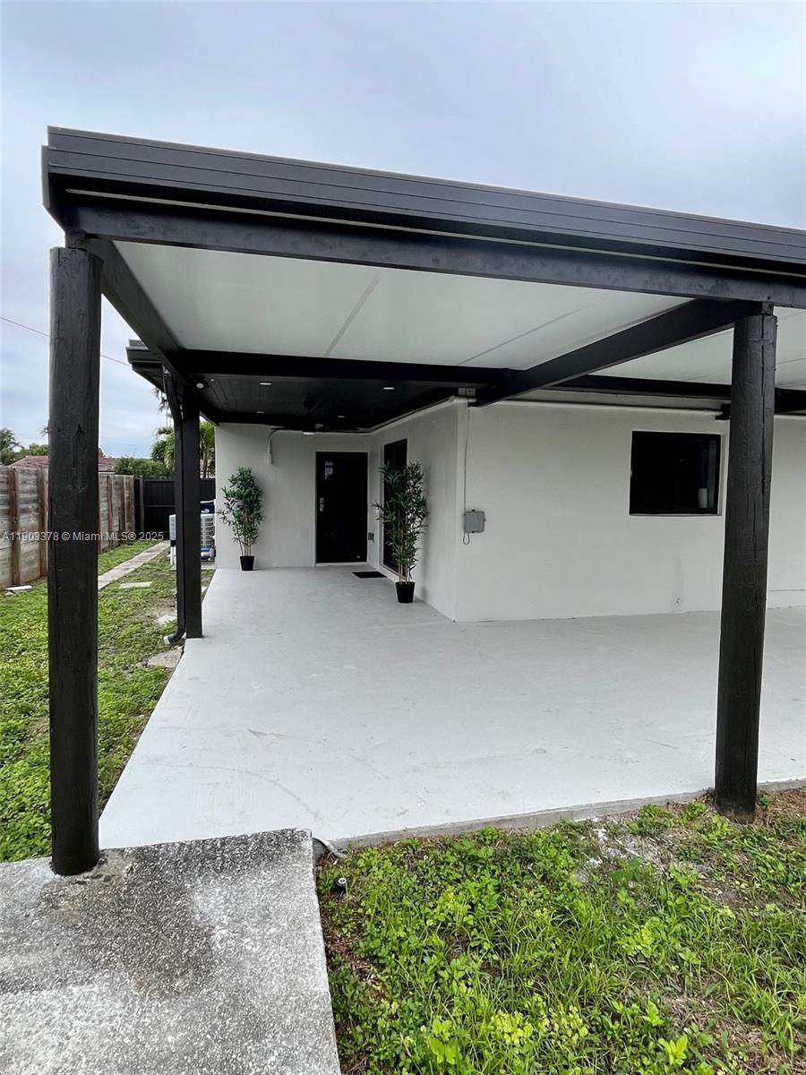 4640 Southwest 94th Court Miami, FL 33165 - Photo 34 of 37 a view of water heater room with two wooden cabinet