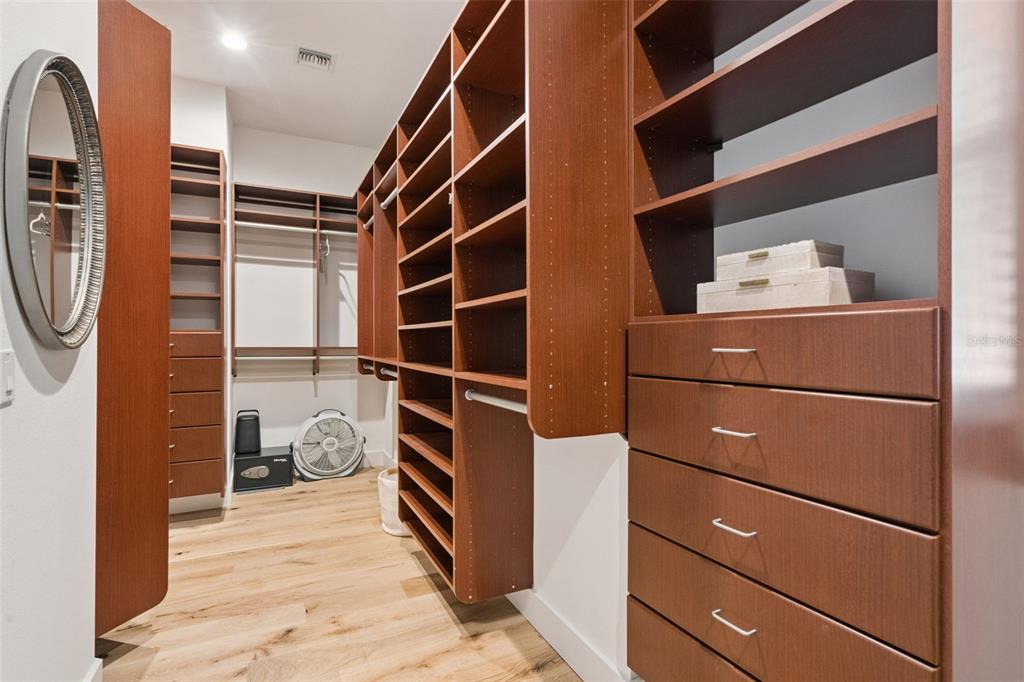 908 Croton Road Celebration, FL 34747 - Photo 33 of 86 a view of walk in closet with clothes and shoes