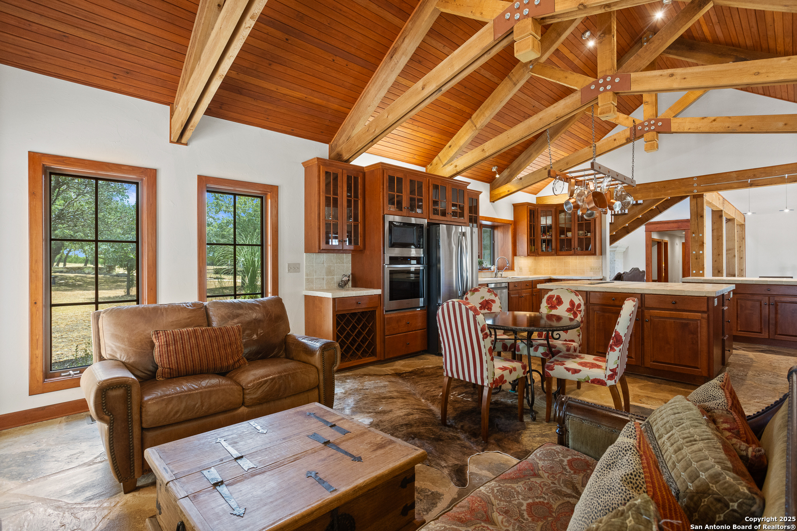 597 Krause Road Pipe Creek, TX 78063 - Photo 16 of 70 a dining room with furniture a rug and a chandelier
