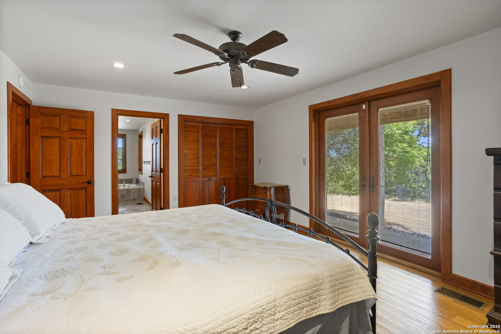 597 Krause Road Pipe Creek, TX 78063 - Photo 18 of 70 a bedroom with a large bed and a large window
