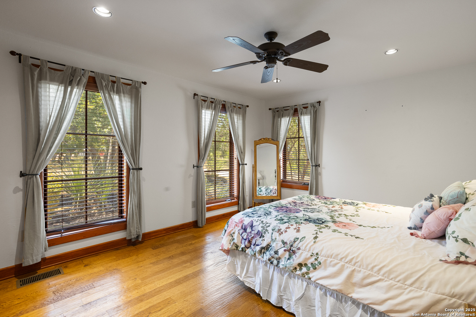 597 Krause Road Pipe Creek, TX 78063 - Photo 21 of 70 a bedroom with a large bed and a large window