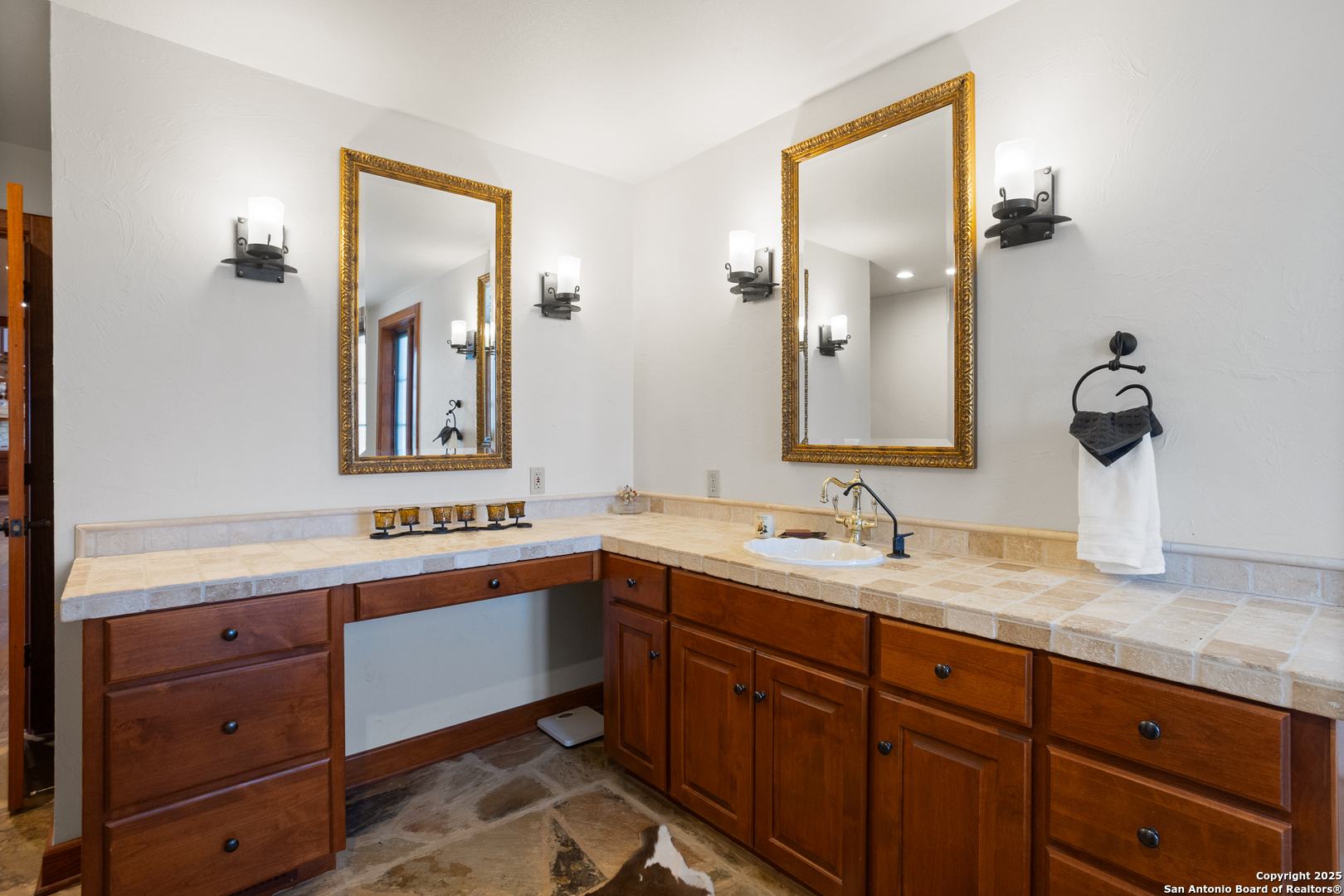597 Krause Road Pipe Creek, TX 78063 - Photo 23 of 70 a bathroom with a double vanity sink and mirror