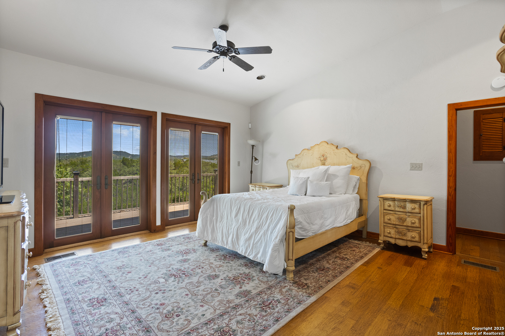 597 Krause Road Pipe Creek, TX 78063 - Photo 25 of 70 a spacious bedroom with a bed and a large window