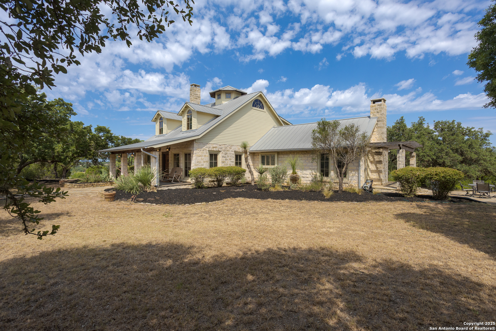 597 Krause Road Pipe Creek, TX 78063 - Photo 31 of 70 a front view of a house with a yard and garage
