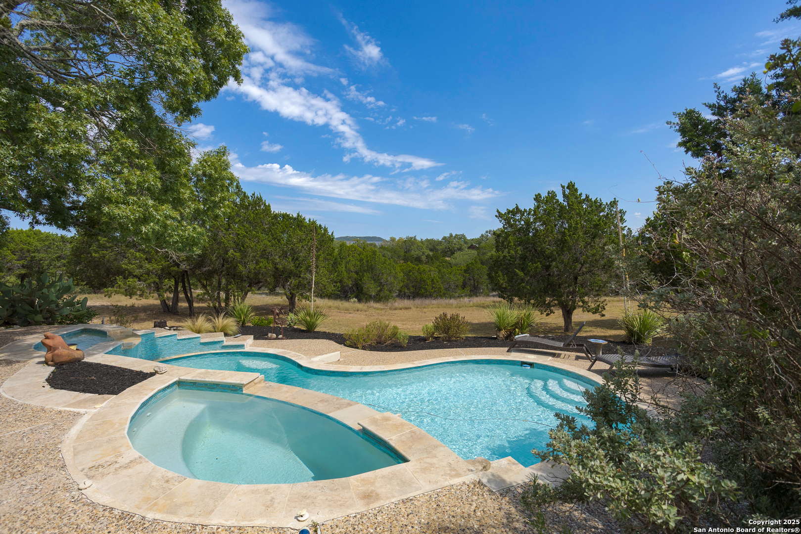 597 Krause Road Pipe Creek, TX 78063 - Photo 37 of 70 a view of a swimming pool with outdoor seating