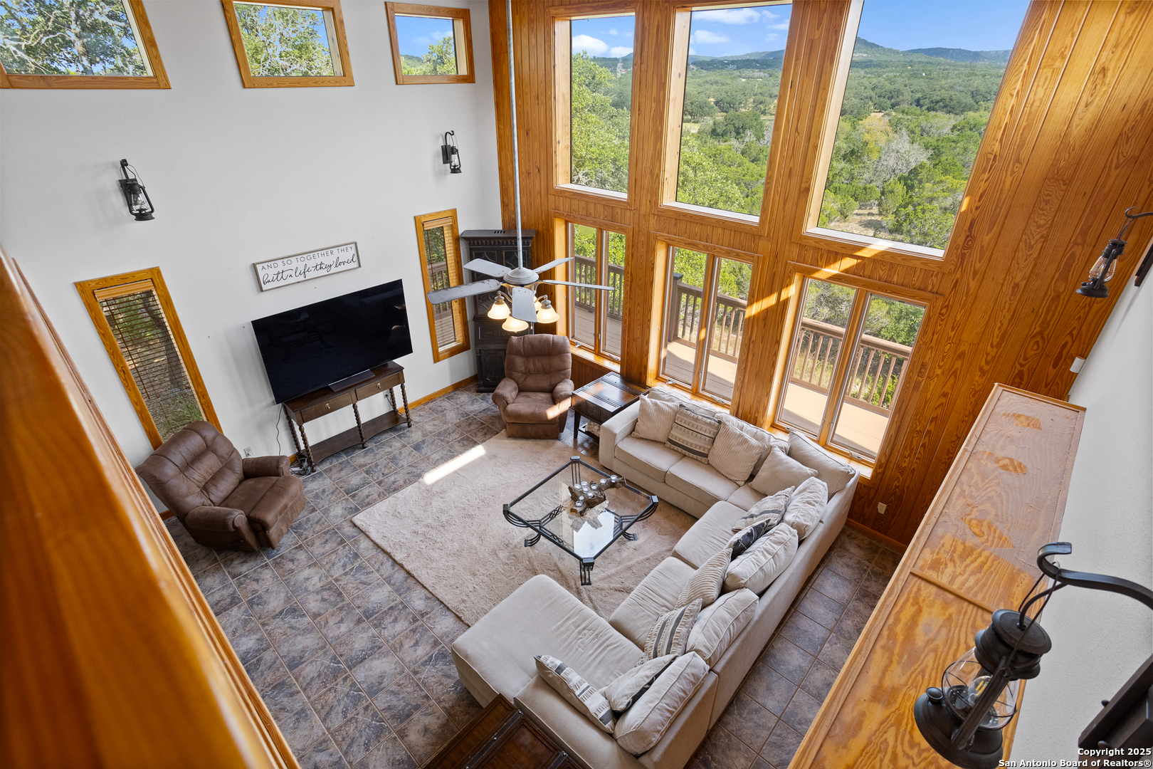 597 Krause Road Pipe Creek, TX 78063 - Photo 61 of 70 a living room with furniture a flat screen tv and a fireplace