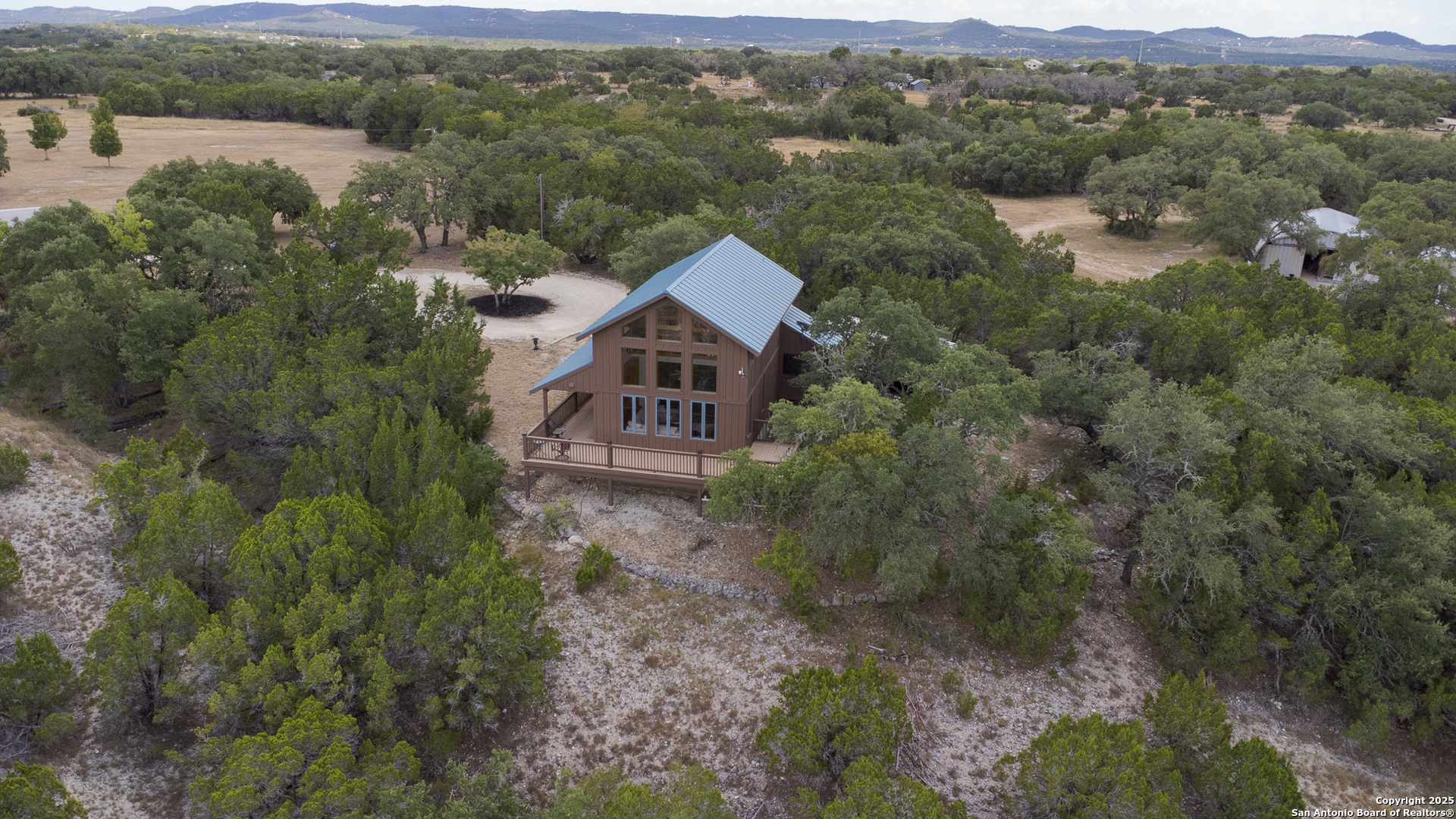 597 Krause Road Pipe Creek, TX 78063 - Photo 65 of 70 an aerial view of a house with a garden