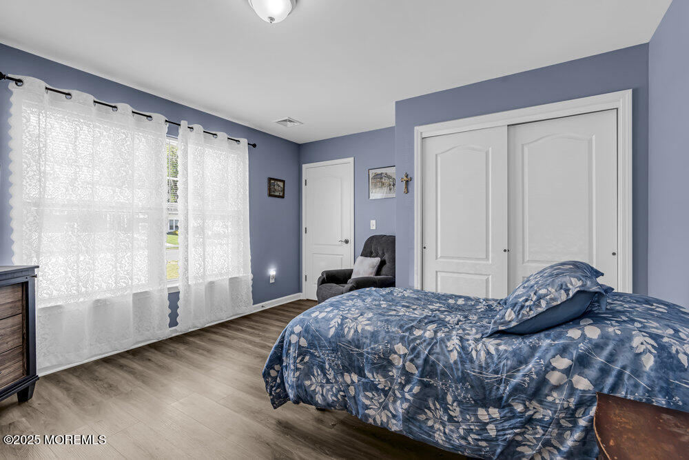 119 Darien Road Howell, NJ 07731 - Photo 21 of 47 a bedroom with a large bed and wooden floor