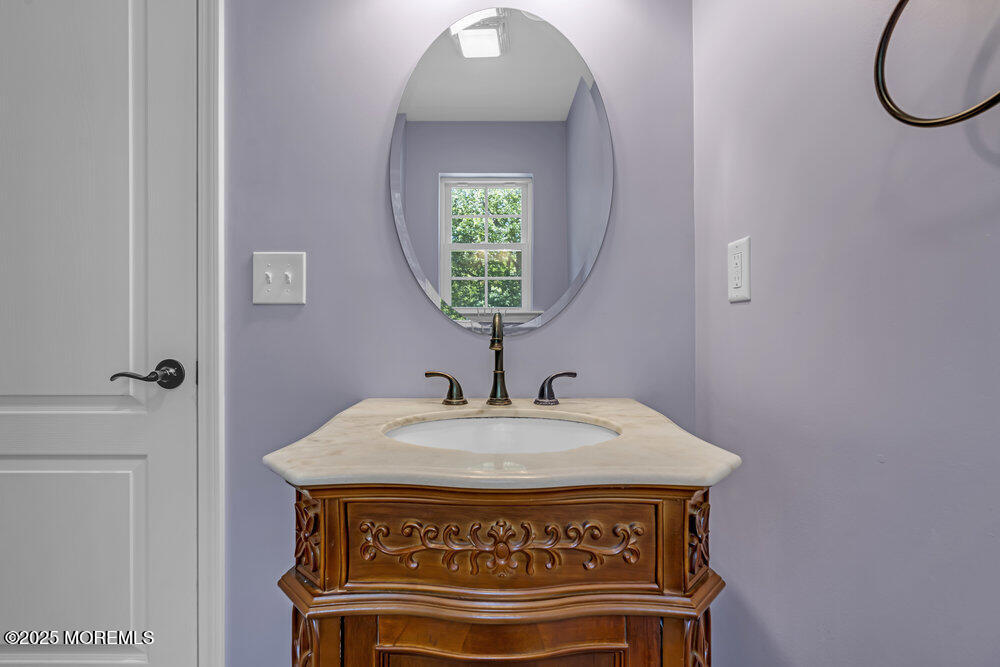 119 Darien Road Howell, NJ 07731 - Photo 23 of 47 a view of a hallway with a sink and a mirror