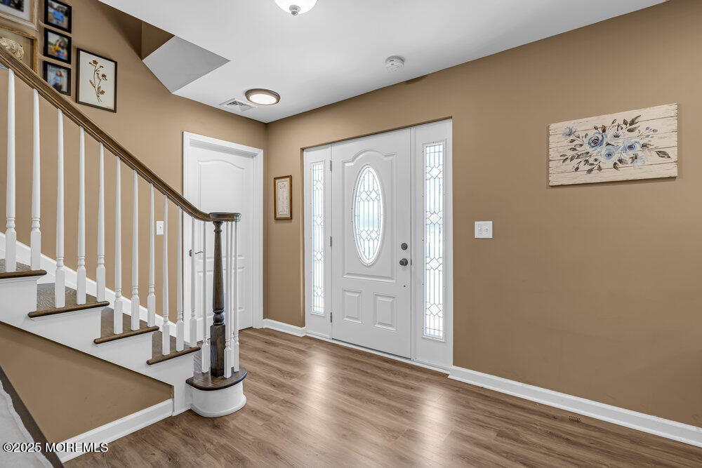 119 Darien Road Howell, NJ 07731 - Photo 4 of 47 a view of a hallway with wooden floor and staircase