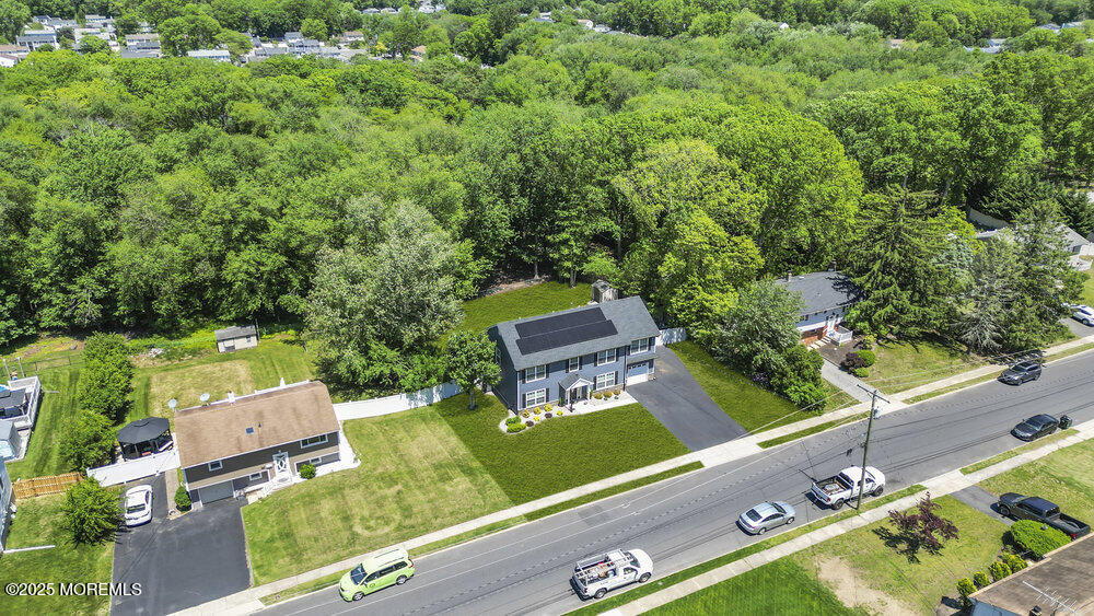 119 Darien Road Howell, NJ 07731 - Photo 41 of 47 an aerial view of a tennis ground with a large trees