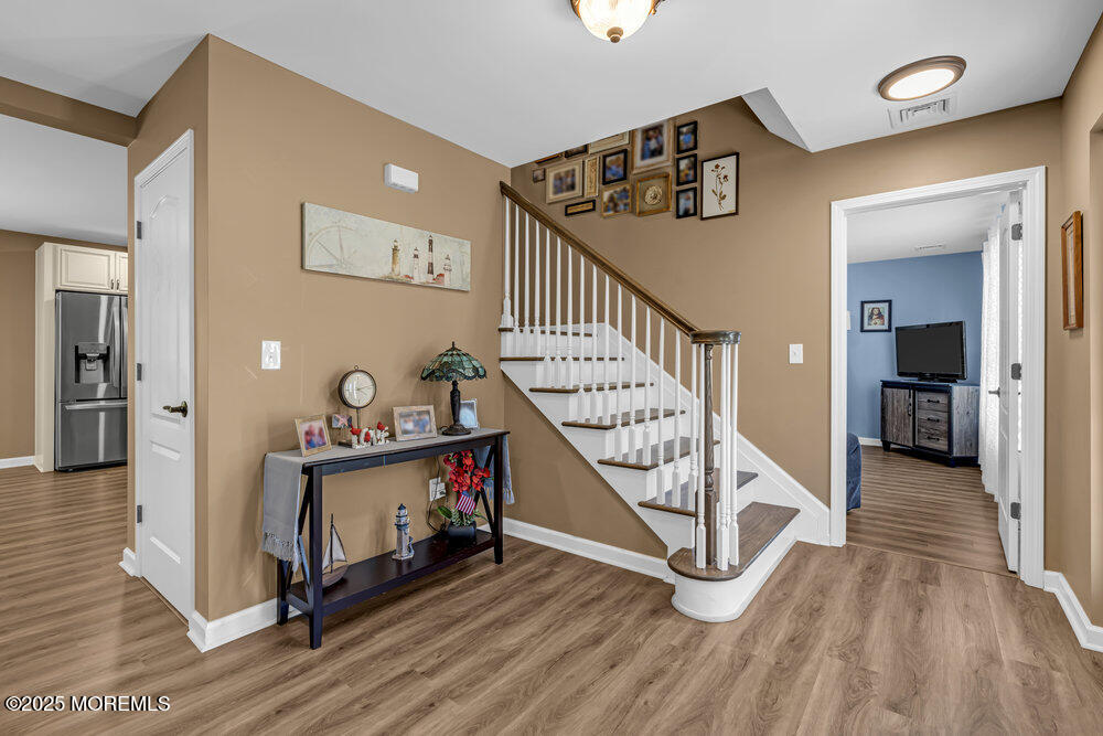 119 Darien Road Howell, NJ 07731 - Photo 5 of 47 a view of a hallway with wooden floor staircase and a living room