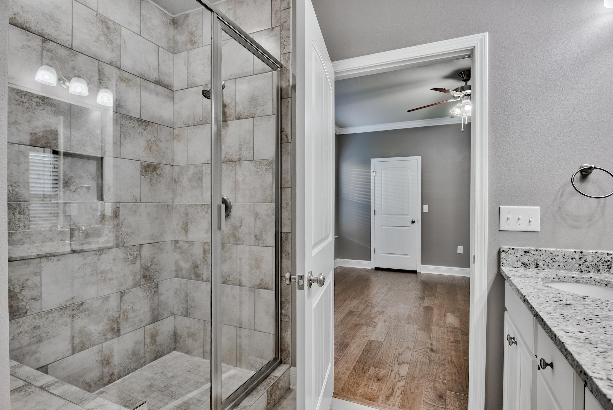 242 Pin Oak Loop Santa Rosa Beach, FL 32459 - Photo 14 of 43 a bathroom with a granite countertop shower mirror and a sink
