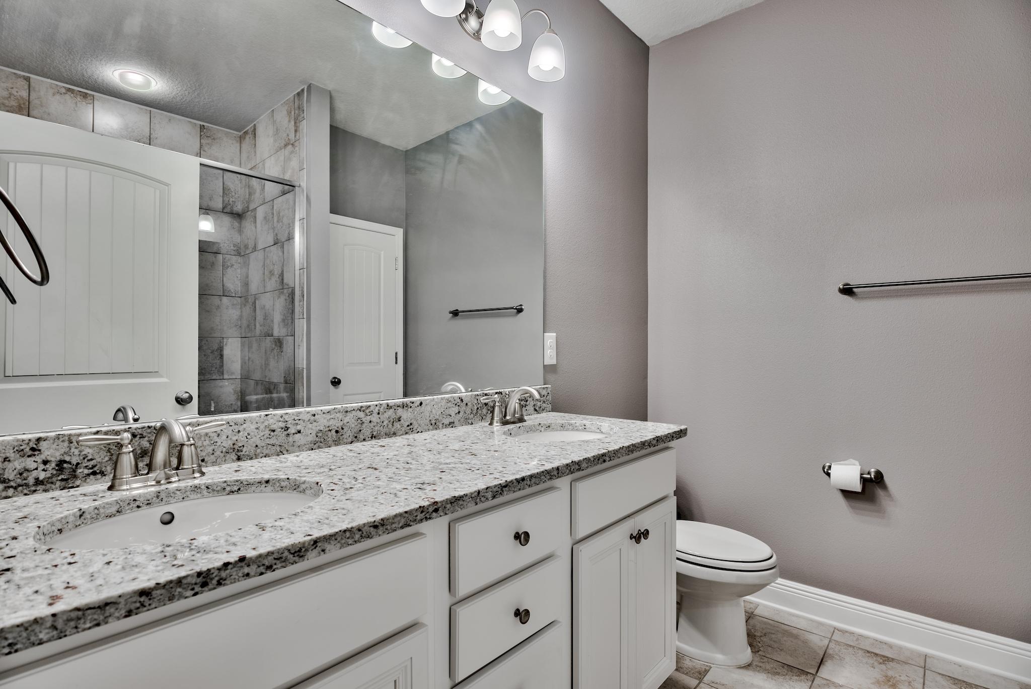 242 Pin Oak Loop Santa Rosa Beach, FL 32459 - Photo 15 of 43 a bathroom with a granite countertop sink toilet and shower