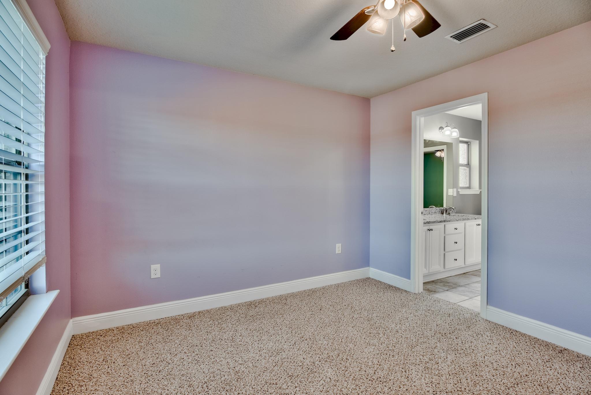 242 Pin Oak Loop Santa Rosa Beach, FL 32459 - Photo 26 of 43 an empty room with chandelier fan and windows