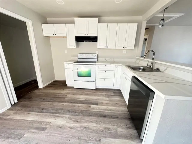 a kitchen with a sink stove and refrigerator
