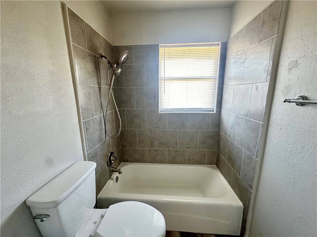 2552 Ave B Ingleside, TX 78362 - Photo 6 of 10 a bathroom with a tub a toilet and a shower