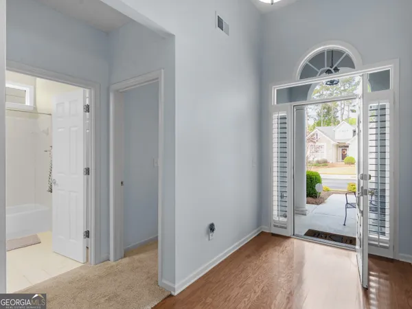 a view of entryway with wooden floor and windows