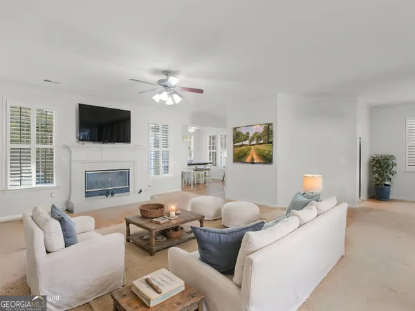 a living room with furniture a flat screen tv and a fireplace